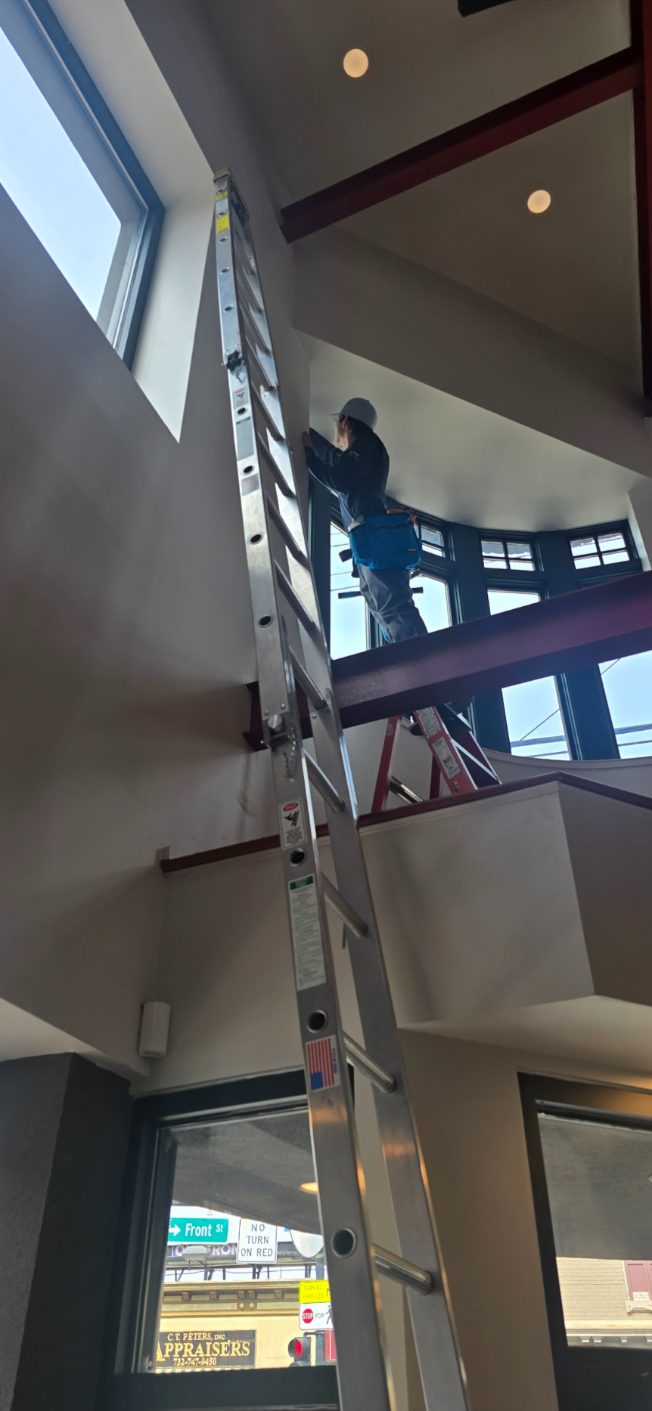 Cleaning windows in a two-story commercial atrium