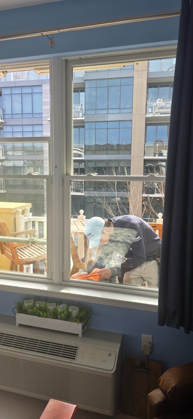 Owen Window Care technician cleaning condo windows