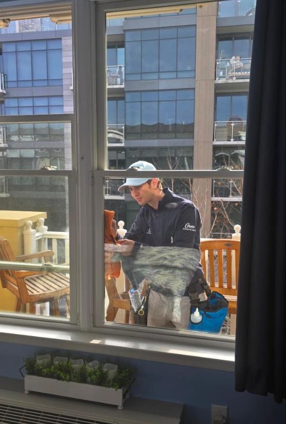 Owen Window Care technician cleaning condo windows