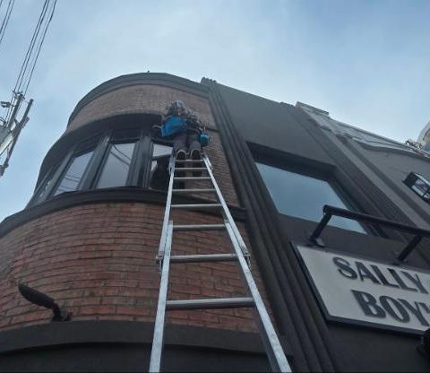 Ladder work on a brick commercial building