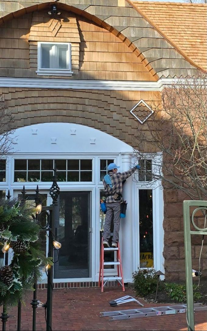 Owen Window Care cleaning the windows of a cedar-shingled Jersey Shore home